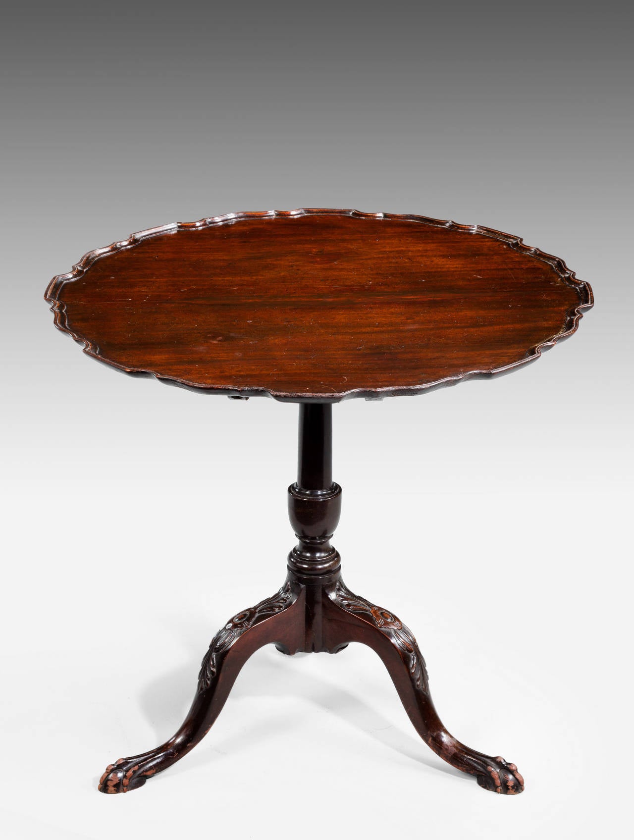 A Chippendale style mahogany dish-top tilt table. The wavy top over well carved supports.

RR.