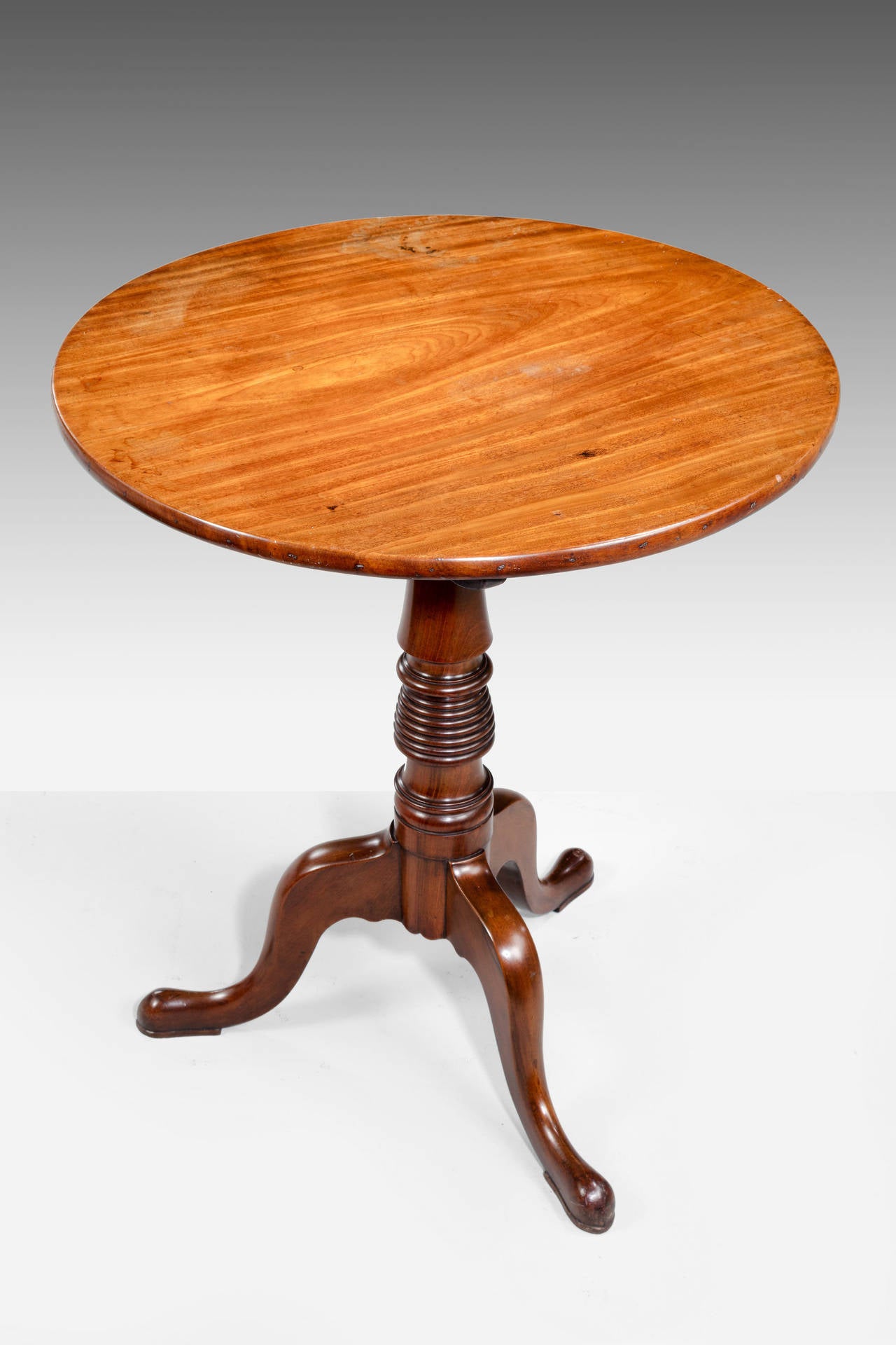 A very finely figured George III period mahogany tilt table. The central support with beehive section over three cabriole legs. The top very finely figured with wild and striped timbers.

RR.