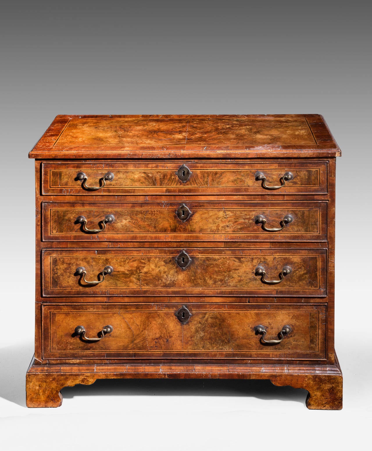 A North Country mid-18th century walnut chest of drawers, with highly figured timbers. Crossbanded and ebony and box wood lined inlay. Good period swan neck handles.