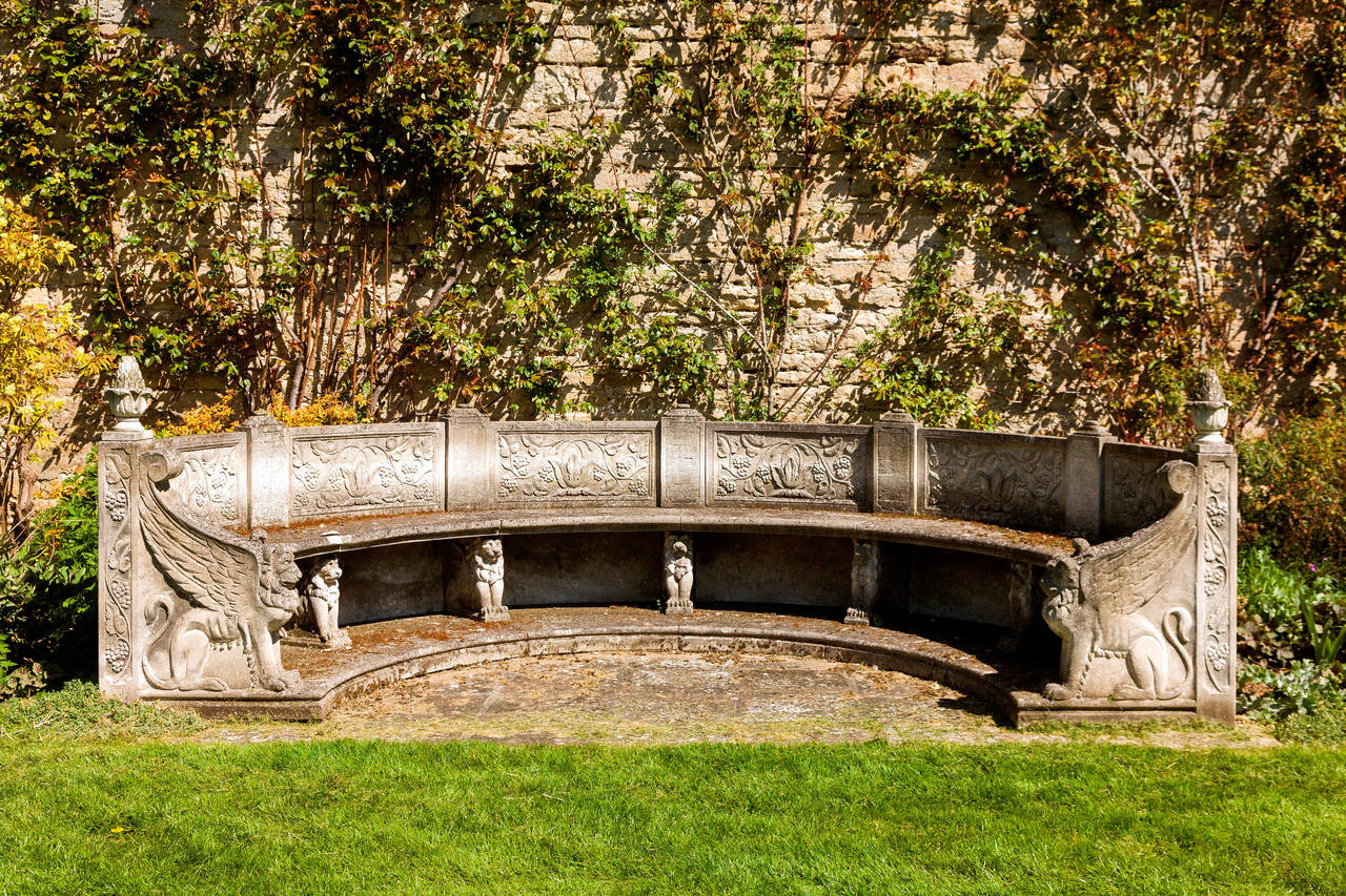 A large and very fine late 20th century stone concave seat with elaborately carved supports and back panels, excellent overall condition.