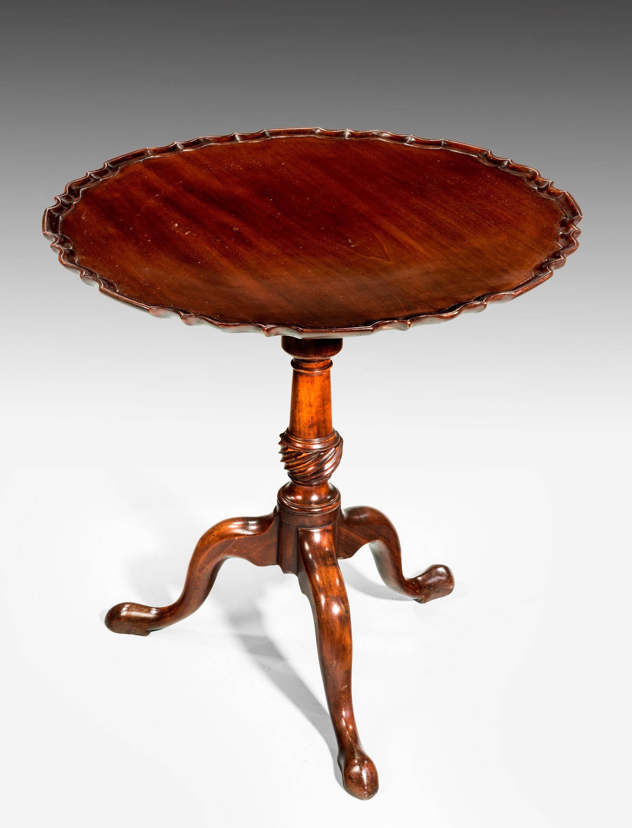 George III period Dish Top Table, the shaped centre support finely carved over cabriole legs.The top with a bird cage action with a scalloped border to the top edge, dating from the last quarter of the eighteen century.

RR
