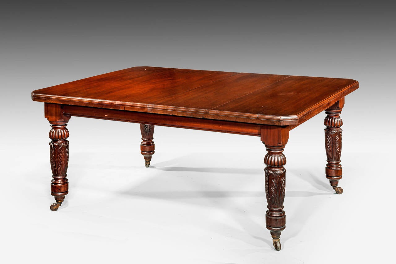 A William IV period mahogany dining table with two extra leaves capable of seating from 6-8-10 people. The wind out action with a period winding handle, the supports finely carved. Over original shoes and casters.
