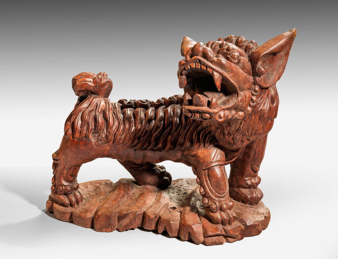 A ferocious carved wooden dog, probably intended as a temple guard.