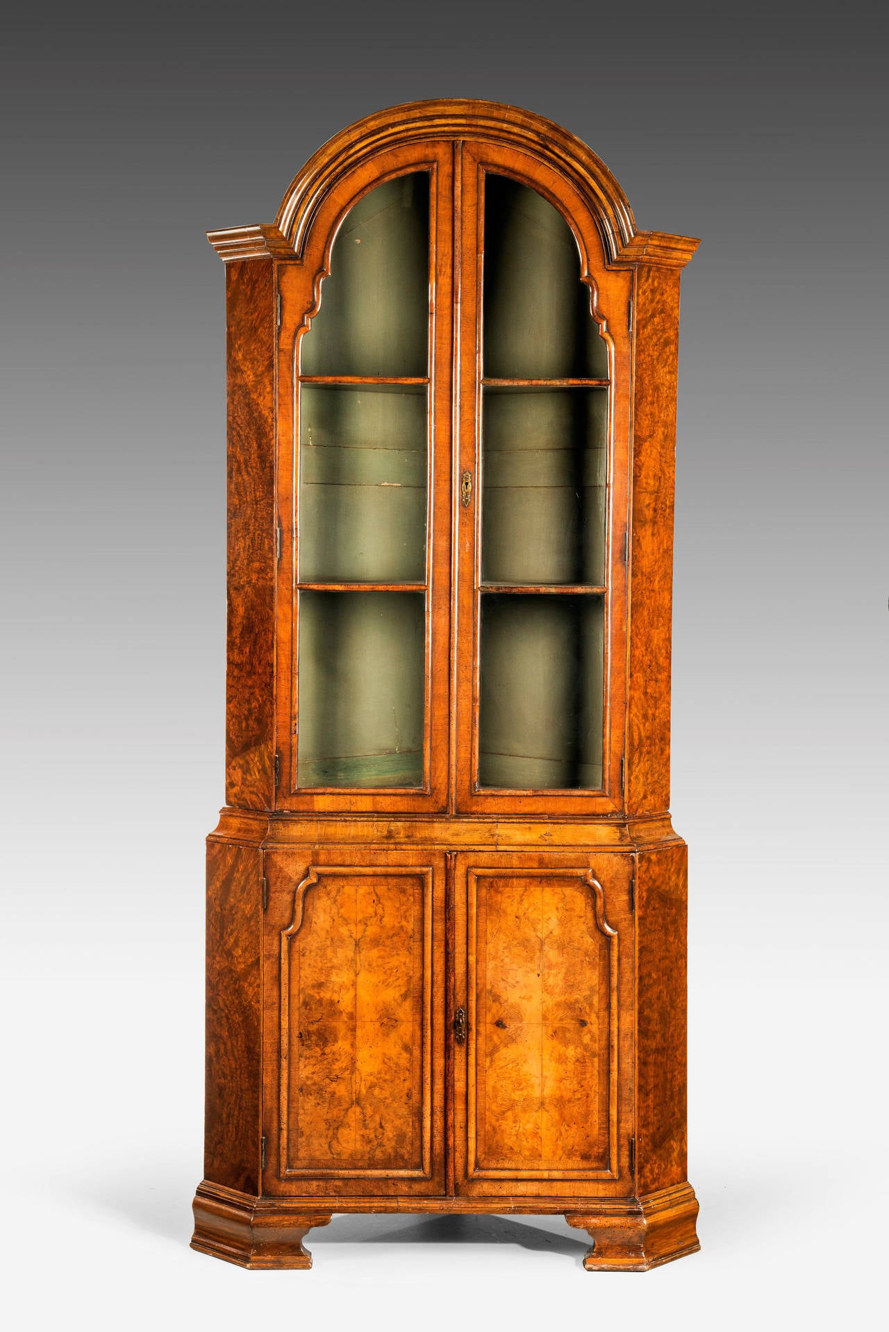 A beautifully figured Walnut Cupboard of Queen Anne Design. With shaped and tier mouldings and inset contrasting frames to the lower drawers. Original ogee bracket feet, all of the very best quality with a fine warm, honey colour.