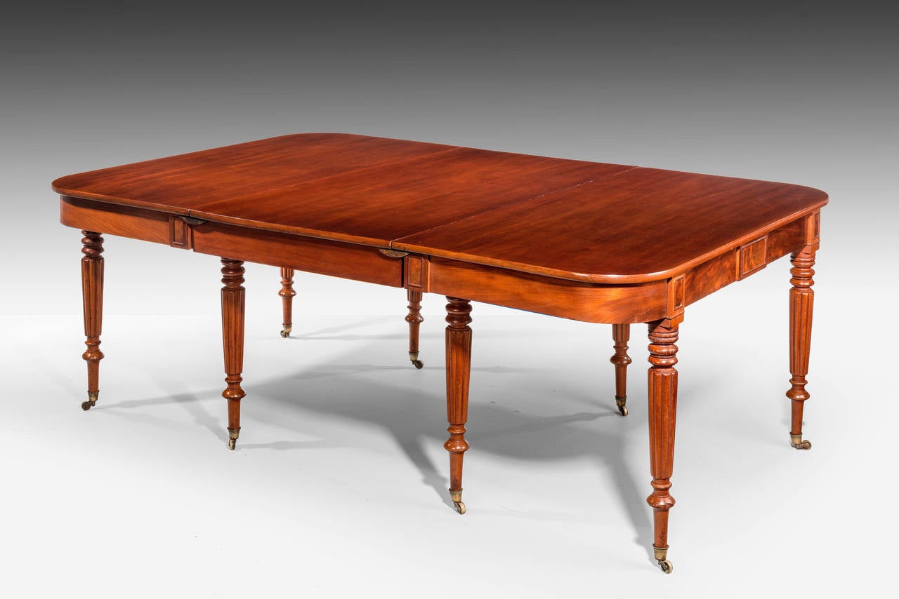 A Regency period three-part D-end dining table. Very well figured timbers with excellent colour and patina. The supports turned and reeded retaining original shoes and casters. One extra leaf.

RR The price of dining tables, Richard Gillow wrote