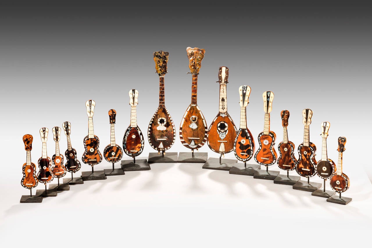 A rare collection of sixteen late 19th century miniature instruments of guitars etc. Beautifully made with applied bone decoration, largely of tortoiseshell with fine mother-of-pearl inlay.

