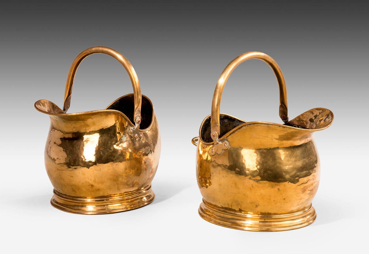 An unusual pair of shaped brass coal helmets with swing handles. Ovid bodies over shaped basses. Excellent overall condition.

