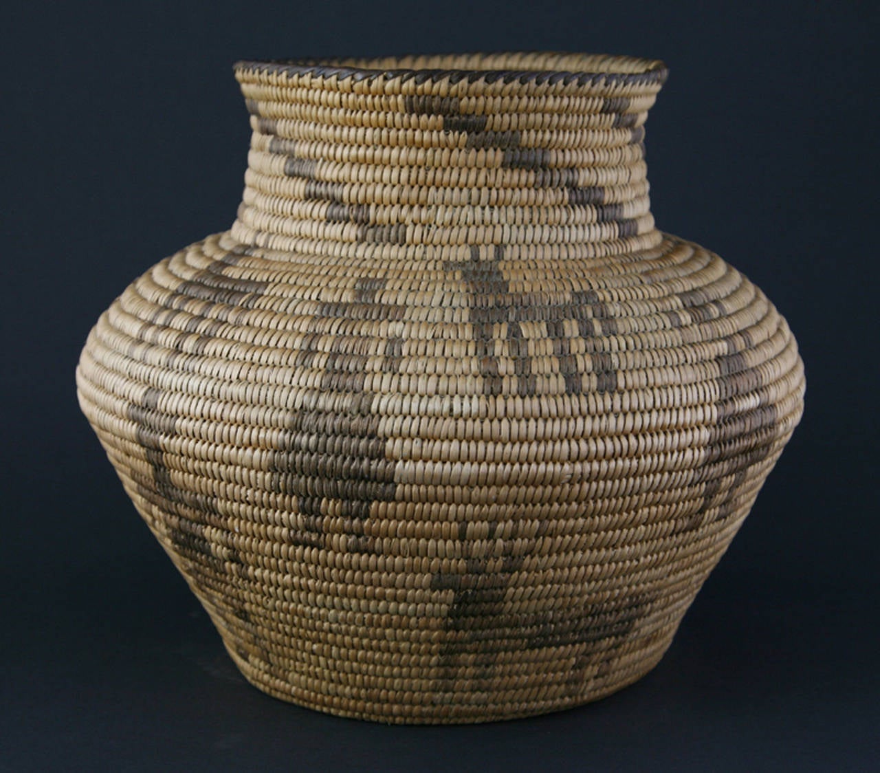 Rare Pima Olla from the 1920s. Figurative basket with male/female figures and dogs. This basket was made for self use for the storage of grain. Made near Phoenix Arizona.