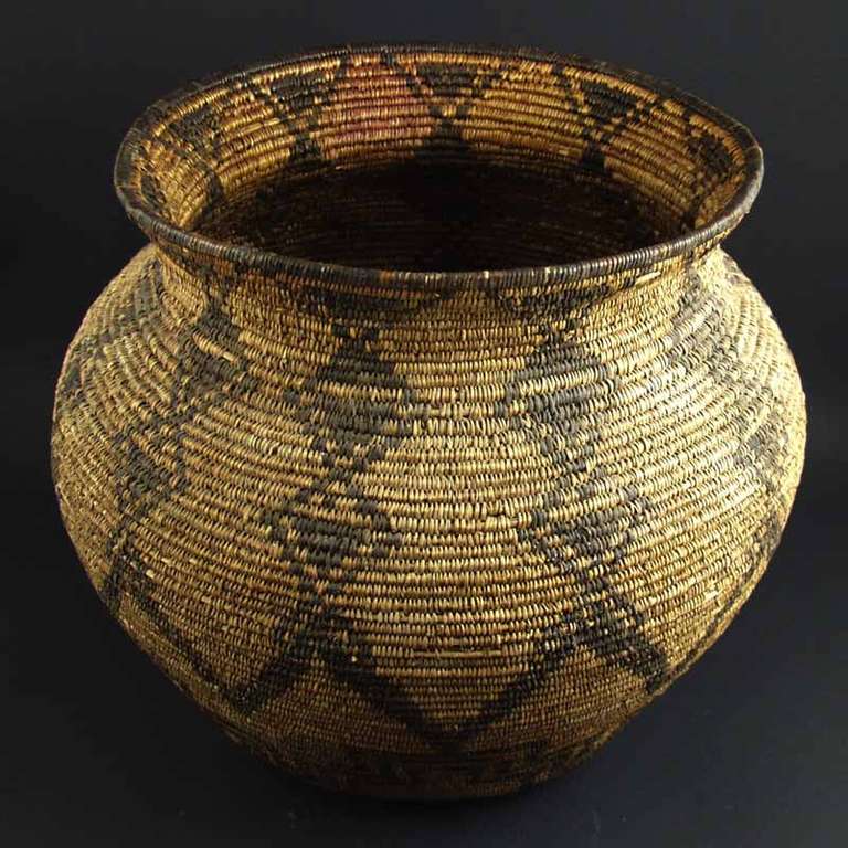 Apache olla, circa 1890s. Very good condition. This is a very large olla that would have been made for self use by the Apache Indians of Arizona. Constructed from willow and devil's claw.