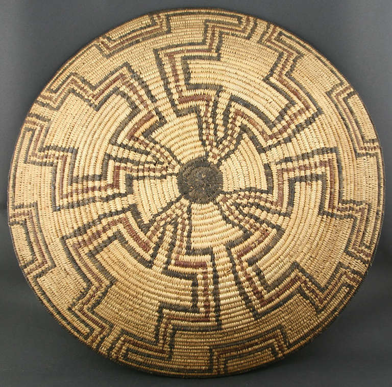 Large polychrome Apache basket. Baskets of this diameter are very rare. This was made at the turn of the century in Central Arizona. Would make a wonderful wall hanging.