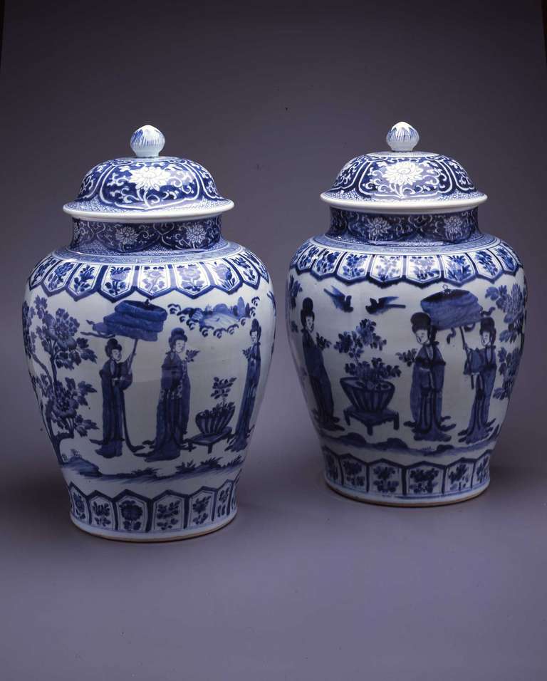 A Pair of Large Blue & White Baluster Jar & Covers

Each heavily potted jar of baluster form with low domed cover and bud-form knop, supported on an unglazed foot-rim with flat unglazed base.  Boldly painted around the body with scenes of two