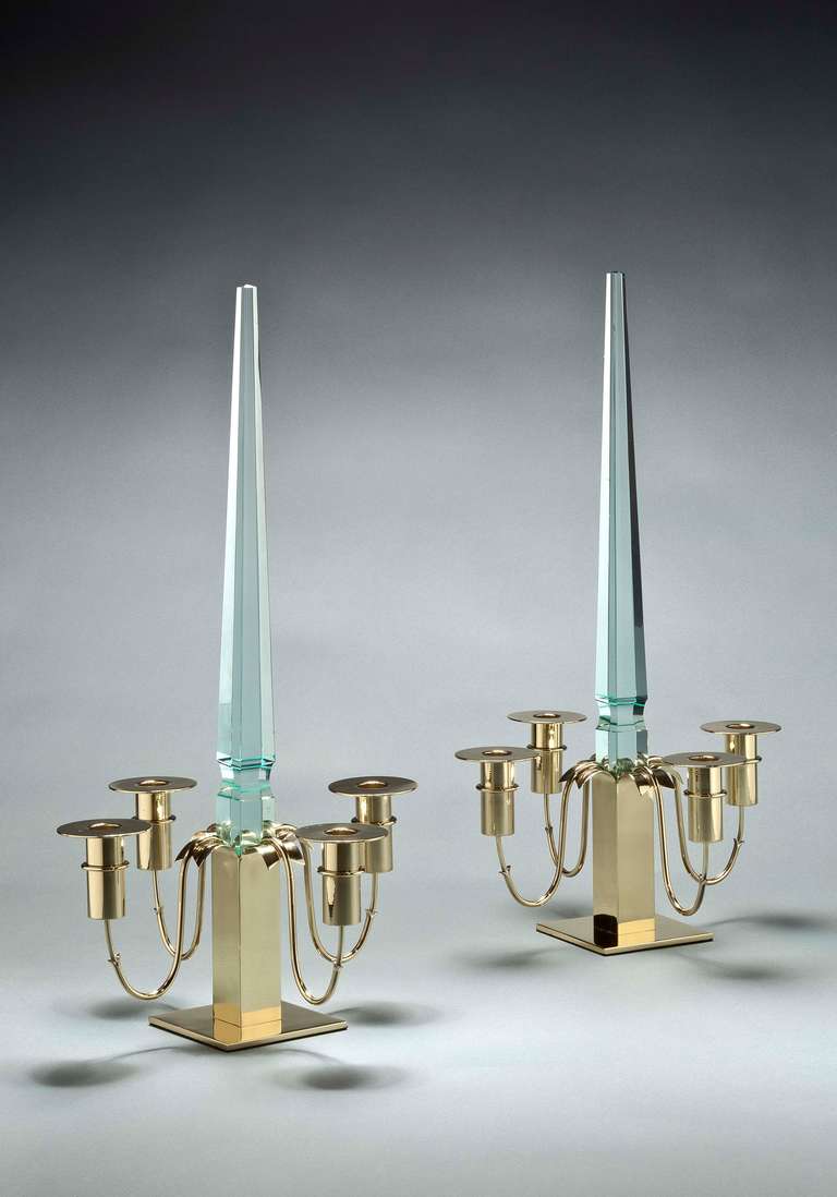 Pair of candelabra with four curved U-shaped brass lacquered hooks holding up a glass obelisk, each base marked with the Fontana Arte mark.
