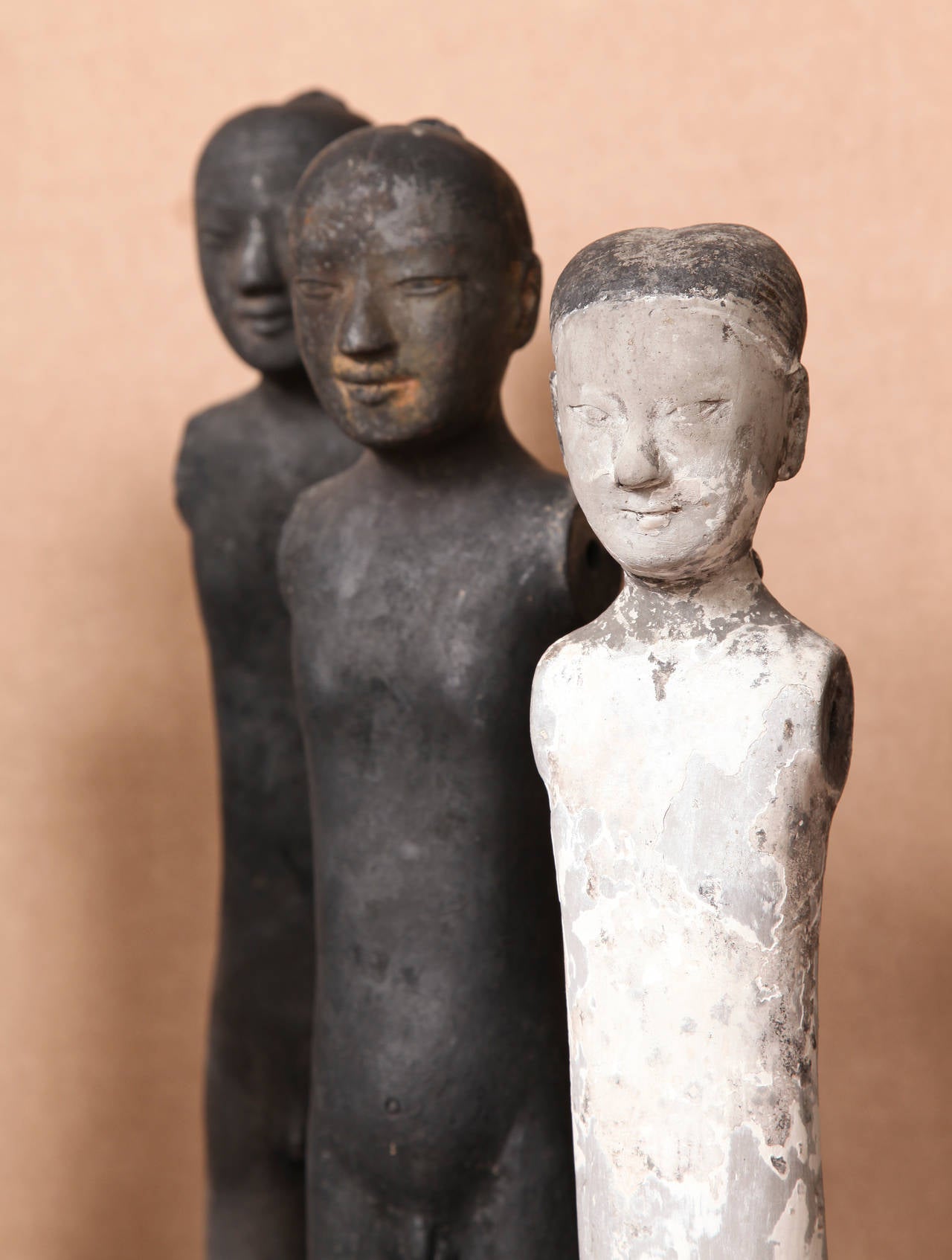 Made from a two part mold, these figures were used in tomb burials beginning in the 2nd century BCE.  These tomb figures are remarkably different from earlier examples as they are portrayed nude. Originally, each figure would have been fitted with a