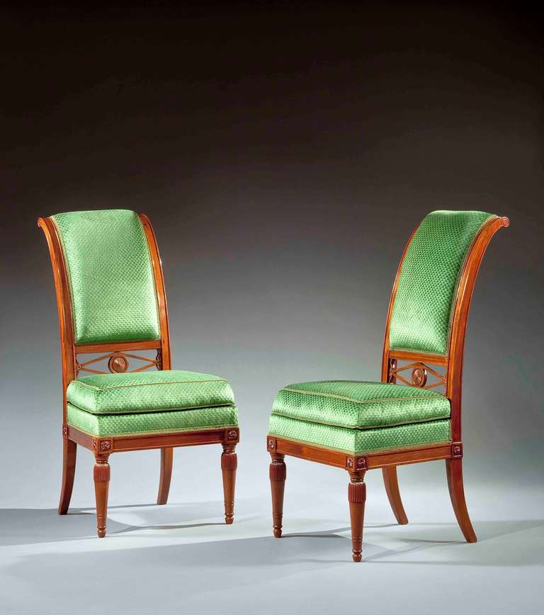 The present chair, designed á la manière des Turcs, with everted arched backs having deep channeling on the side and front rails.  The highly polished and finely grained mahogany seat back is centered by an upholstered section terminating with a