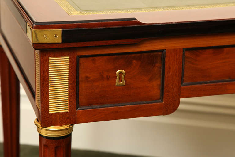 The rectangular mahogany table fitted with a removable top, the case supported by four fluted legs on bronze castors. Two drawers fitted with a lock on either side hold wooden playing pieces: one with chess pieces and another with counter pieces.