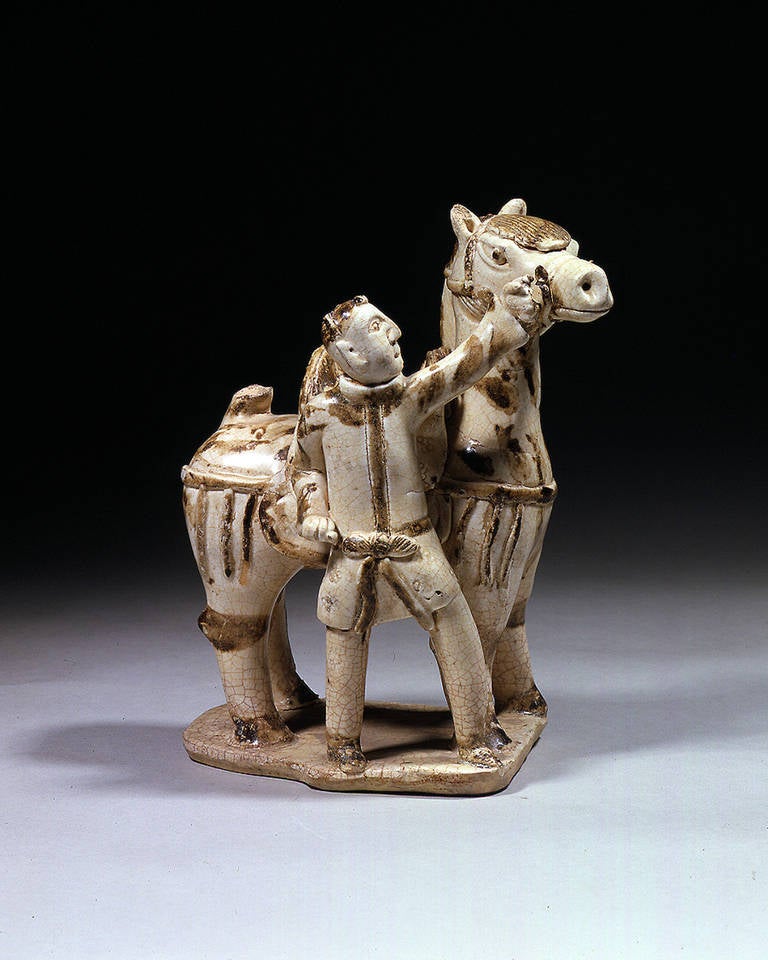 Figure of a groom and horse.