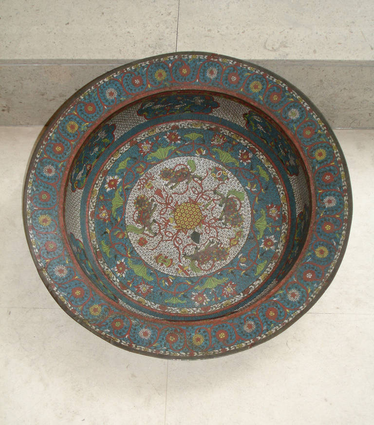 Having central circular medallion with diaper border of lions surrounded by floral diaper borders in blue, red and green enamels.
