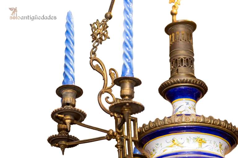 Antique and exclusive single piece of ceiling lamp with Talavera ceramic spherical body with polychrome floral decoration in blue and six metal arms to hold the candles. The straps are segmented metal plant decoration at the junction of the segments.