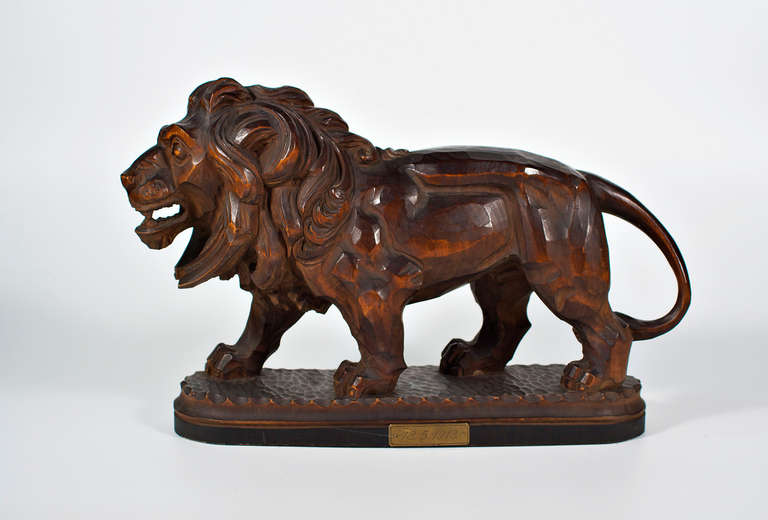 101 year old stylized lion, carved in a really unconventional vincent van gogh look. dated and made out of massive tropical wood