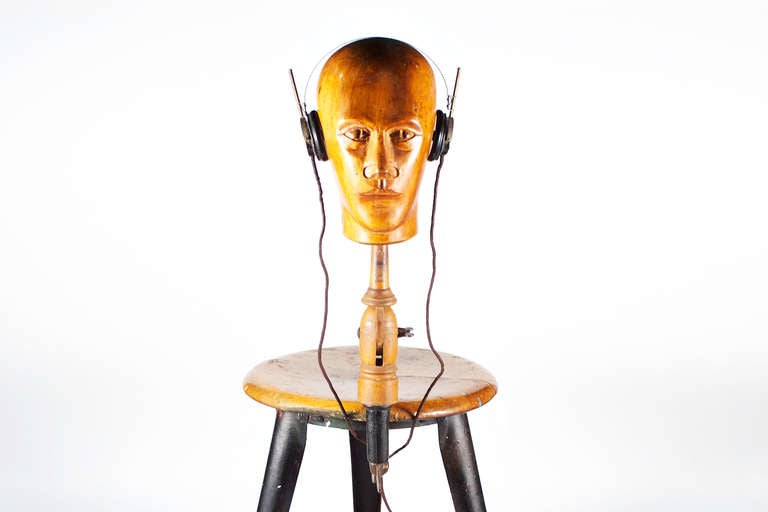 very old Wooden Head, for presentation wigs, hats and headsets, on plint and static adjustment . Same Provenience like Raoul Hausmann used for his Dada-Installations, shows Serial Number.