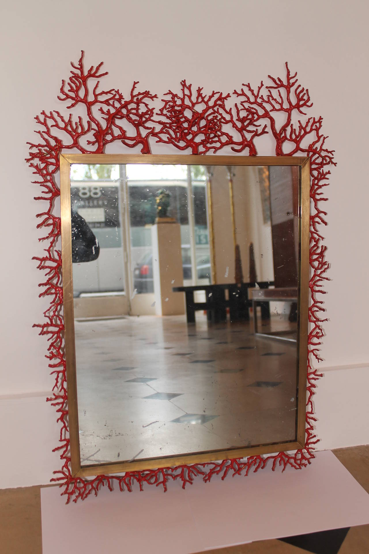 Coral mirror by Robert Goossens (Paris, 1927).
Mercury glass.
Frame in gold brass with “coral roots” decor in bronze lacquered in red,
France, 1972.
Measures: H 70 cm, W 50 cm.
