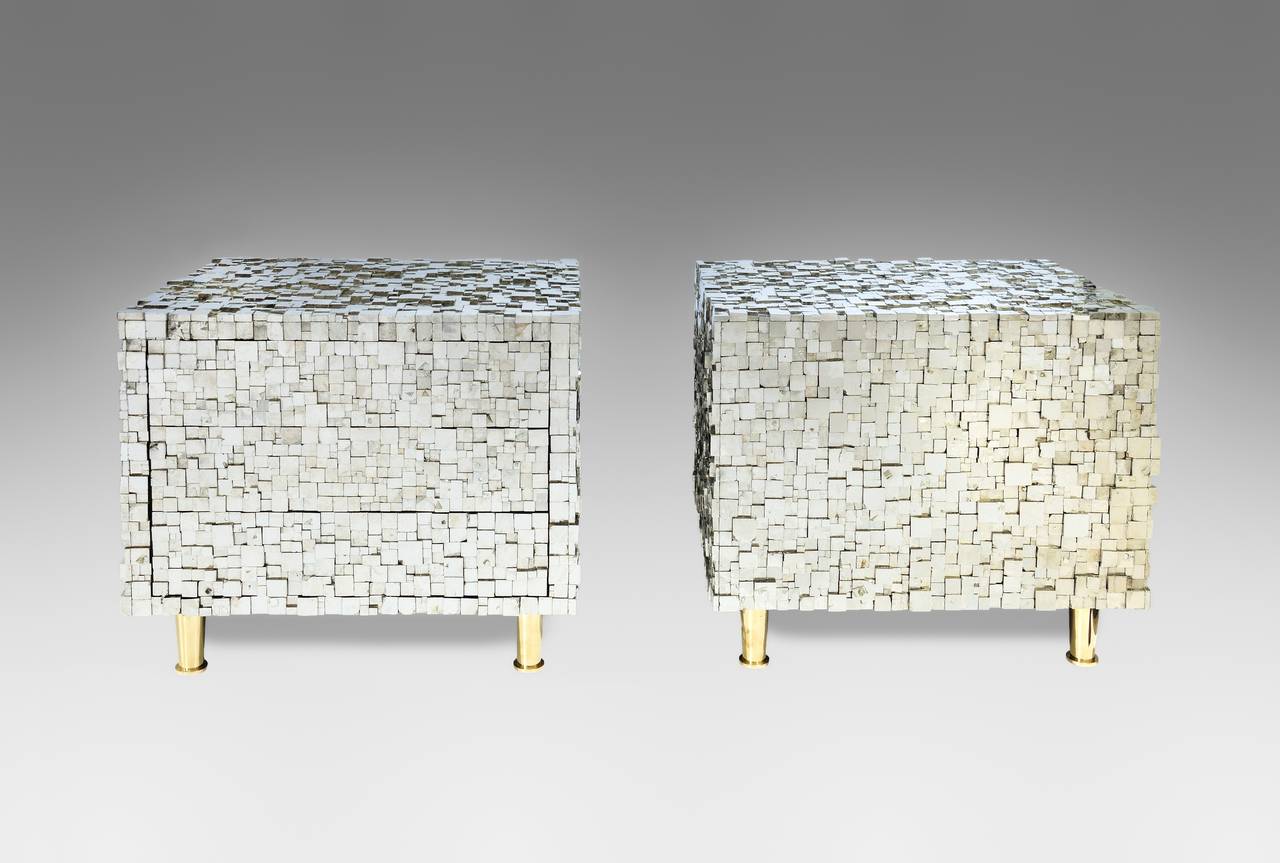 Pair of bedside tables by Kam Tin entirely covered with iron pyrite.
There are three drawers.
Stamped 