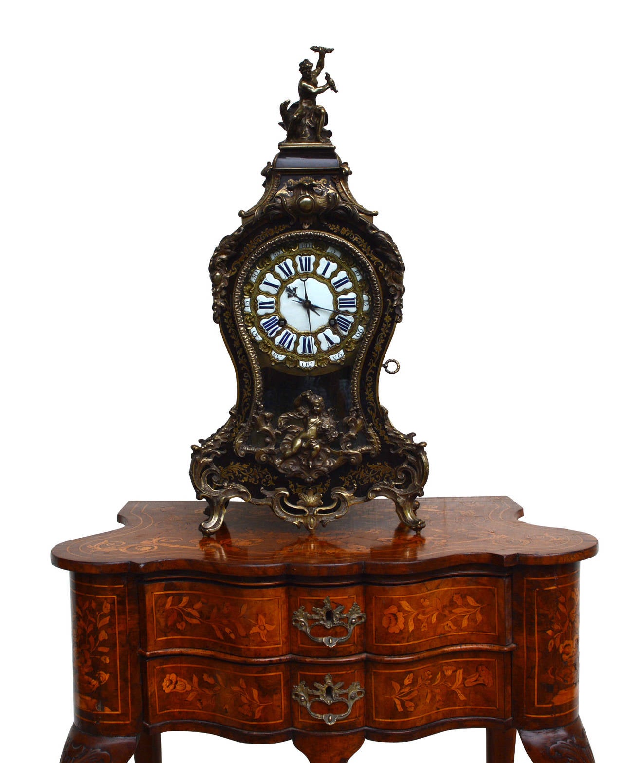Rare Louis XV period table clock, by François Goyer, Paris 1750s.

Exquisite and very rare table clock, richly ornamented with floral elements, a putto, and an allegorical figure. Interior and back with intricate Boulle marquetries. 

Signature