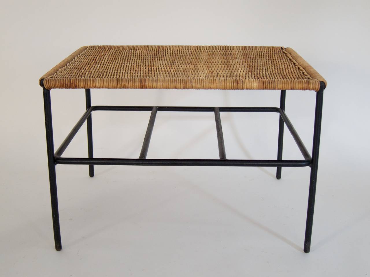Very rare coffee table with a news rack
designed in the 1950s by Carl Auböck
Wicker, black painted steel rods
Good, original condition with minor traces of usage and aging.