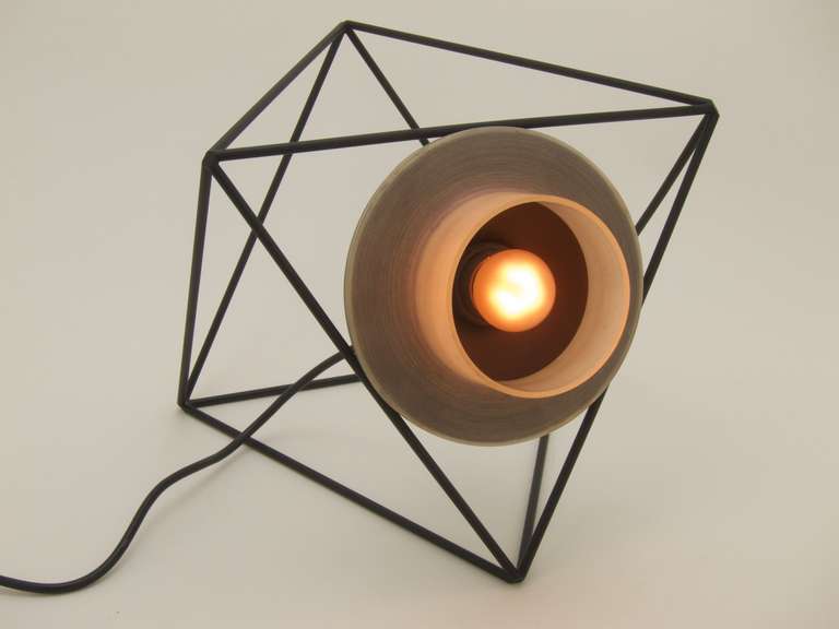 Rare table, wall or ceiling lamp by Felice Ragazzo
1969 for DH Guzzini
modular light system

Polyhedron made of black painted ironrods with a black painted reflector

The polyhedrons can be combined and stacked together in countless variations; the