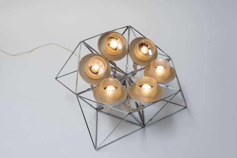 Rare table or floor lamp by Felice Ragazzo

Modular light system

polyhedrons can be combined and stacked together in countless variations; the reflector fits into each side of the polyhedron.
chromed iron wire, matt Makrolon (methacrylate)

This