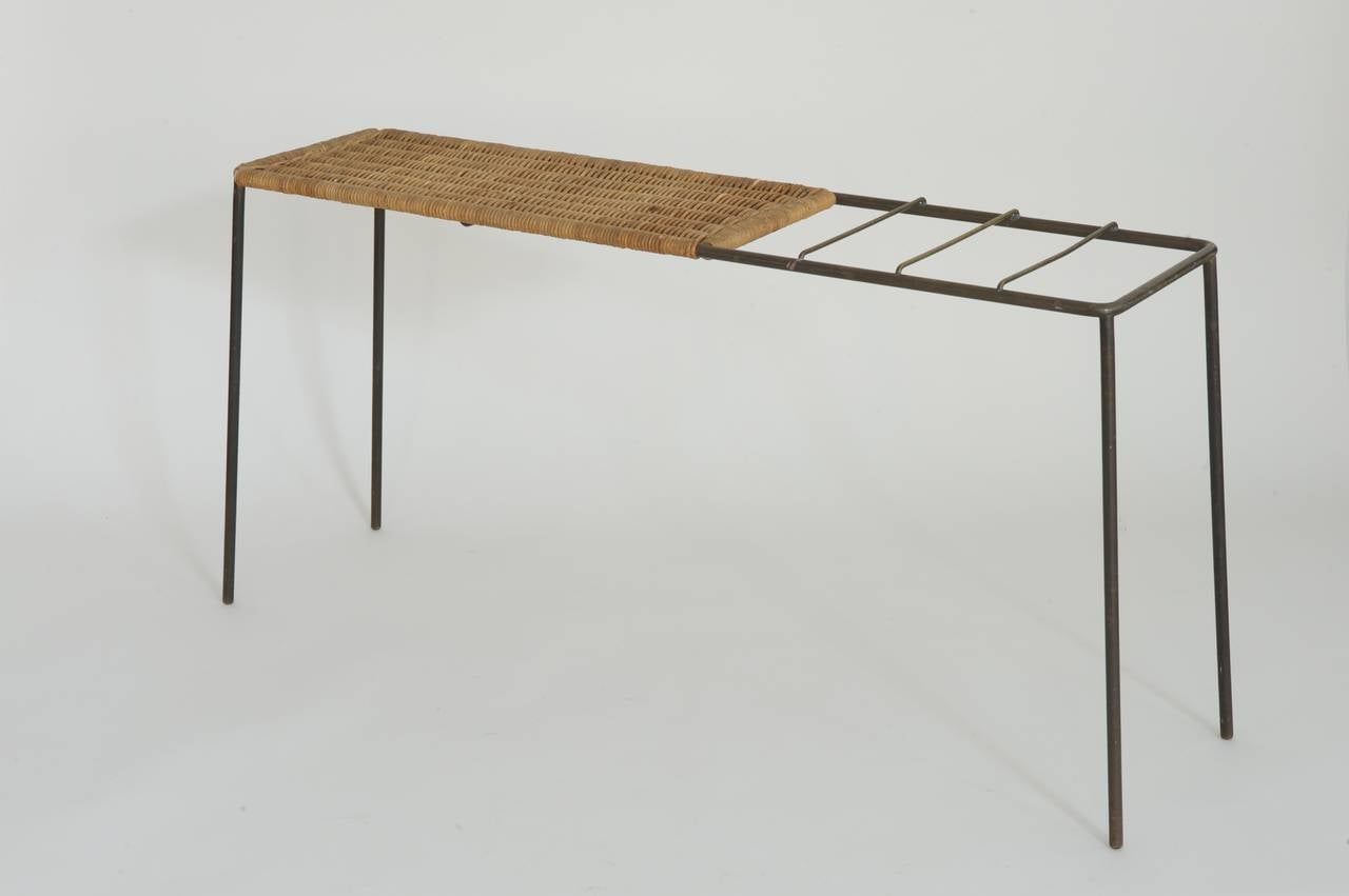 Elegant console table by Carl Auböck.
Brass rods and wicker work.

With integrated umbrella stand.