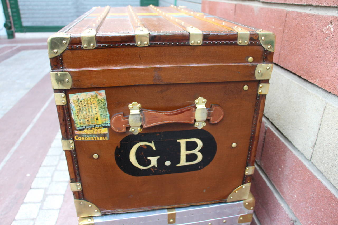 This beautiful trunk features wood slats on warm brown canvas, brass locks and fittings and leather handles. Interior has been relined and has got two removable trays, convenient for storage.
It could be used as a perfect coffee table.
Free