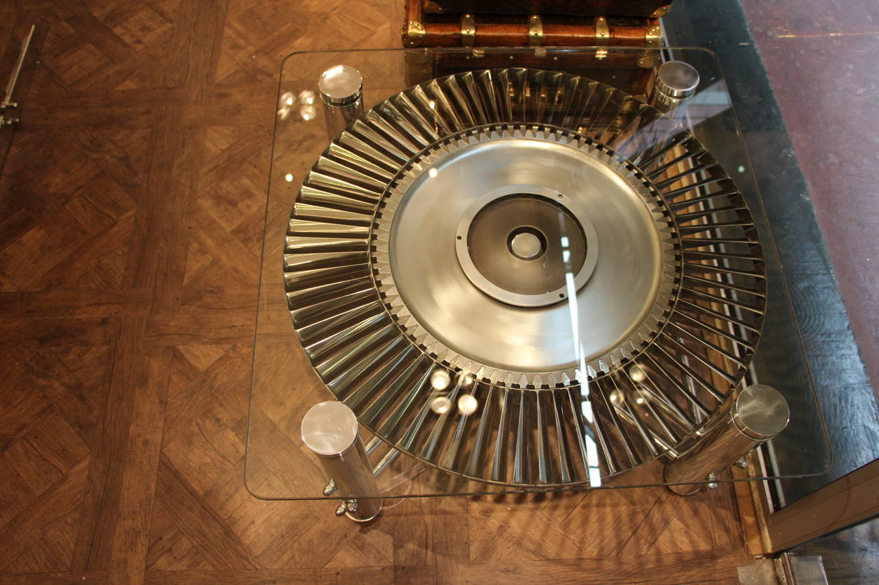 This amazing table has been made from a Rolls Royce jet engine.Each titanium blade has been hand polished .The stator spins around smoothly thanks to ball bearings.
The frame of the table is very sturdy and very well balanced and is all polished