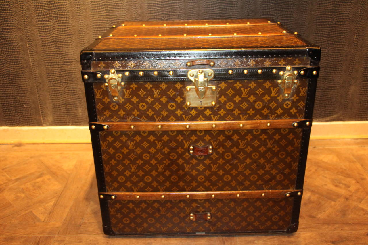 This unusual cube trunk is very elegant and in very good condition. It has got the LV Monogram pattern canvas, all black lozine trim, brass fittings and steel handles. It has got a magnificent warm patina. The interior is complete with its original