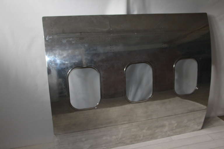 This piece of fuselage coming from a 737 Boeing can easily be used as great piece of decoration upon the wall like a mirror or a paintting.
The outside fuselage has been stripped,sanded and mirror polished to get this fantastic look.
The inside