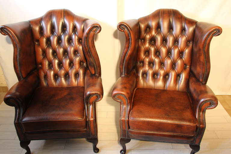This pair of leather wing chairs has got a very nice light brown patina and are very comfortable.