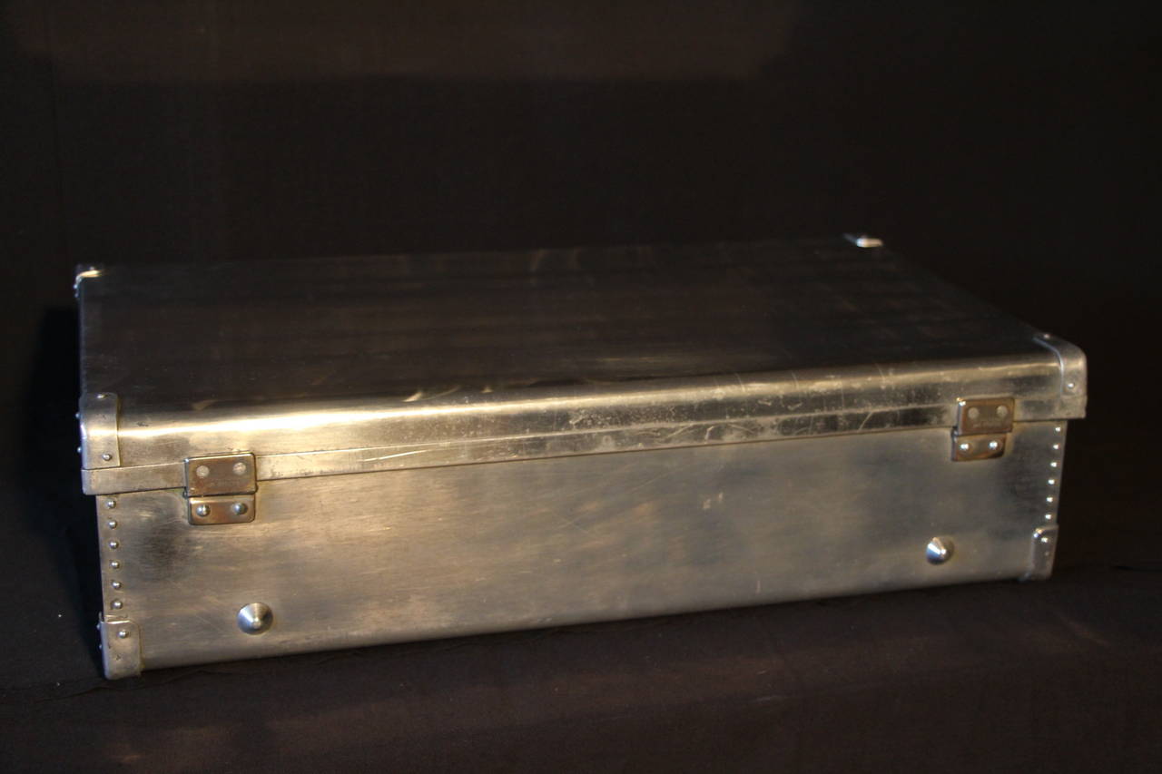 This polished aluminum suitcase is extremely light and can be used for travel as well as a piece of decoration.