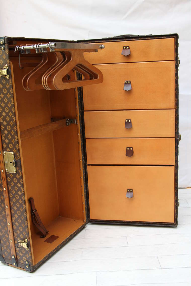 This impressive Louis Vuitton wardrobe features stenciled monogram canvas,lozine trims and brass locks;
The interior has got a folding hanging section and a series of 5 drawers.