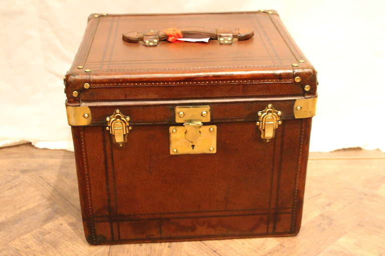 This hat box has got a very nice patina and polished brass fittings.It can be used as a bedside cabinet or end of a sofa.