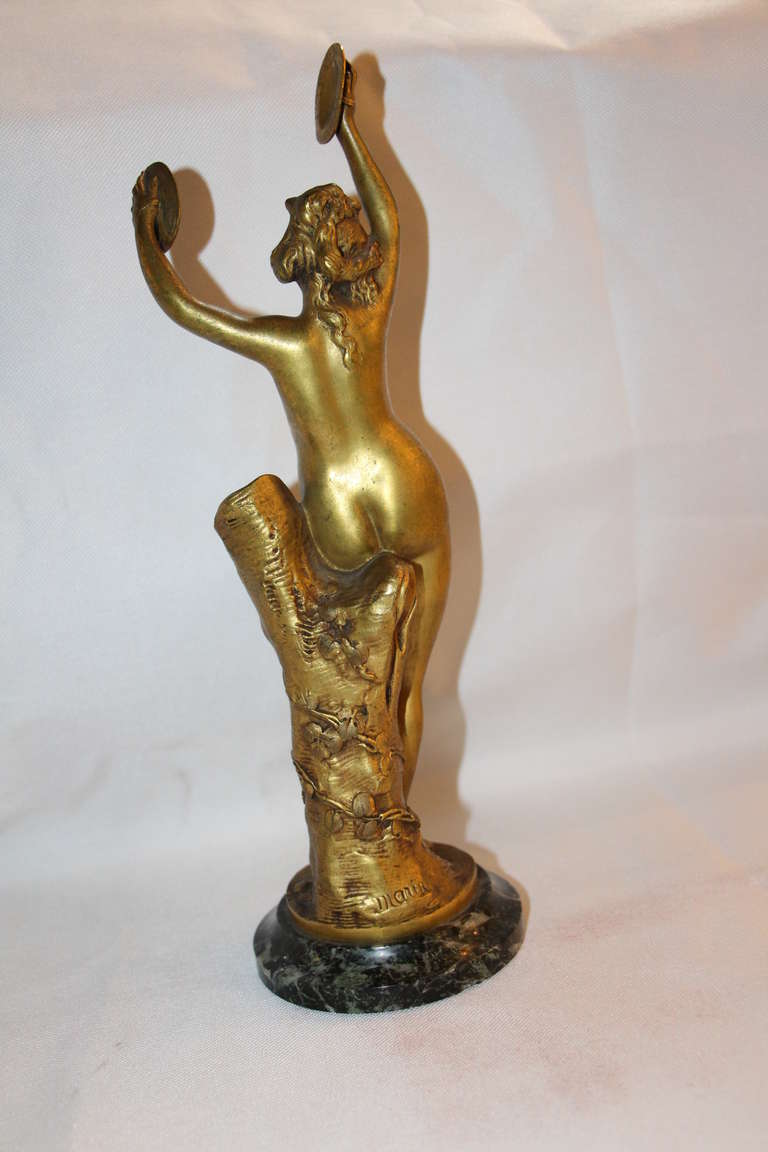 This golden bronze sculpture is very elegant and has got a very warm patina.