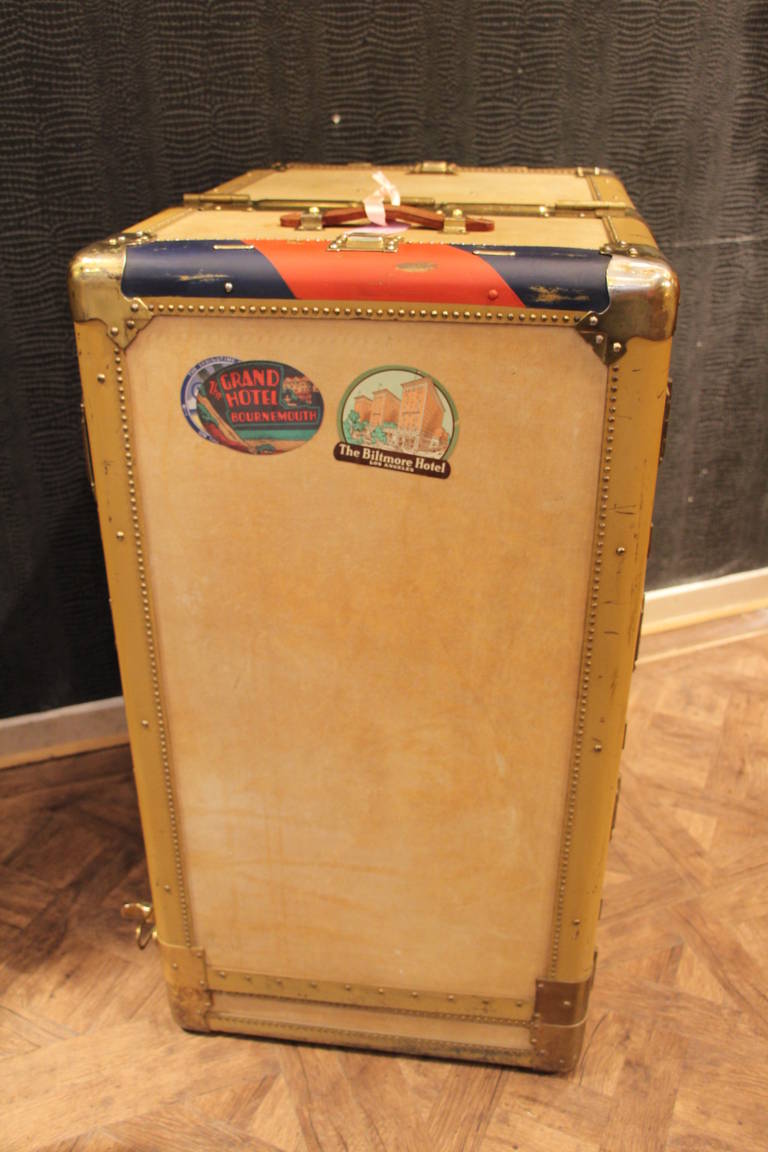 This beautiful vellum wardrobe trunk features two doors,one hiding a folding hanging section and the other hiding a series of six drawers.
This very rare Hartmann  turntable trunk is in beautiful condition. It is made to spin around on end in order