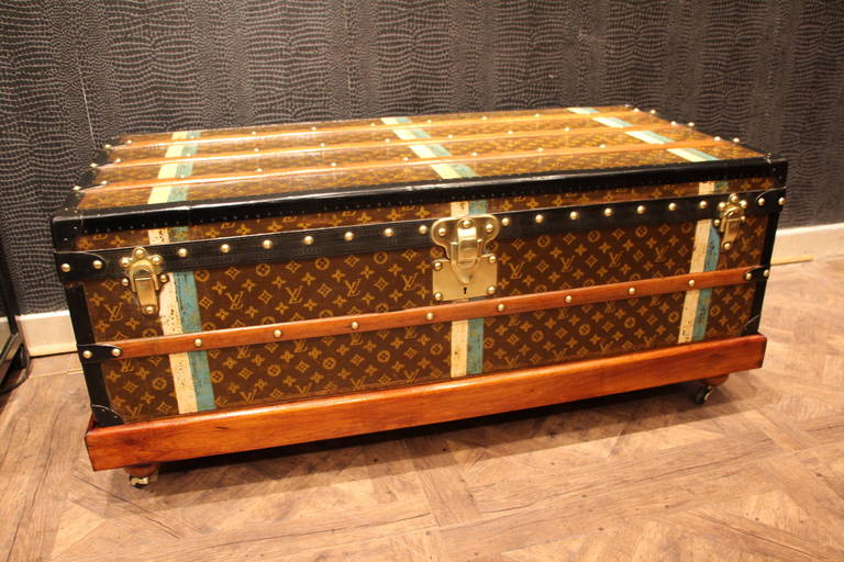 This Louis Vuitton trunk is stenciled monogram canvas and black lozine trim. It has brass locks and a beautiful patina. It has got its original clean and fresh interior.
It has got a wood custom-made stand to get higher and to be used as a coffee