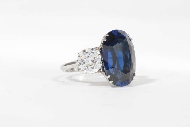 Magnificent  Costume Jewelry Simply elegant faux 14 carat superb faux manmade Kashmir color oval sapphire  ring set with cubic zircons in white gold, presently size 6 and a half but may be sized  before shipping complimentarily. Quite elegant and