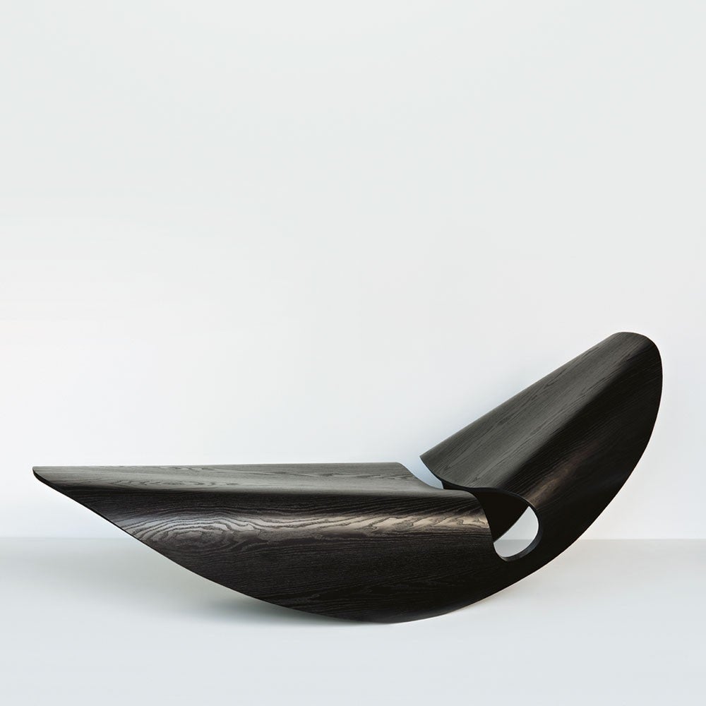 The concave lines of seashells inspire the Cowrie Rocker. The curvilinear forms of the elegant rocking lounger are the result of an extensive research and innovation process, which unites the handmade with the digital. Sweeping lines are displayed