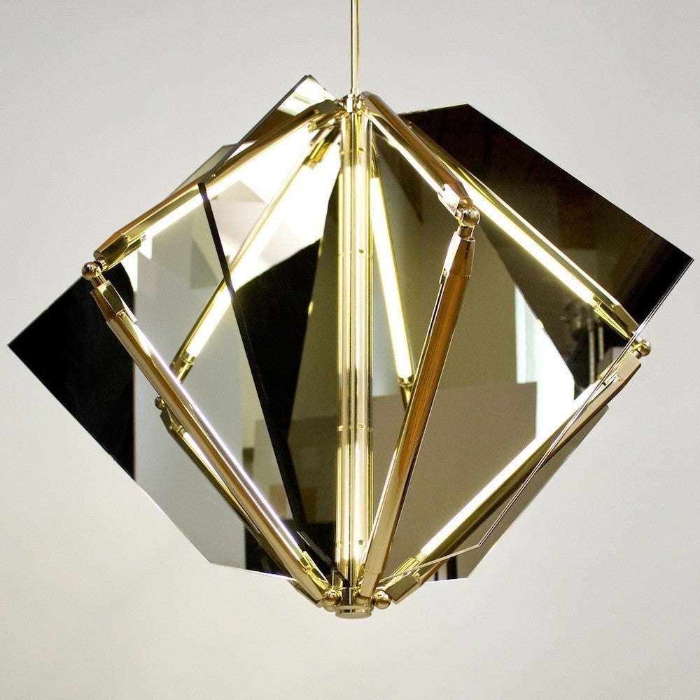 Echo uses fins of mirror radiating from a central axis to reflect beams of light. Led tubes are turned inward to bounce off the glass; the light becomes both softened and multiplied. Also available with fins of glass which diffuse light and softly