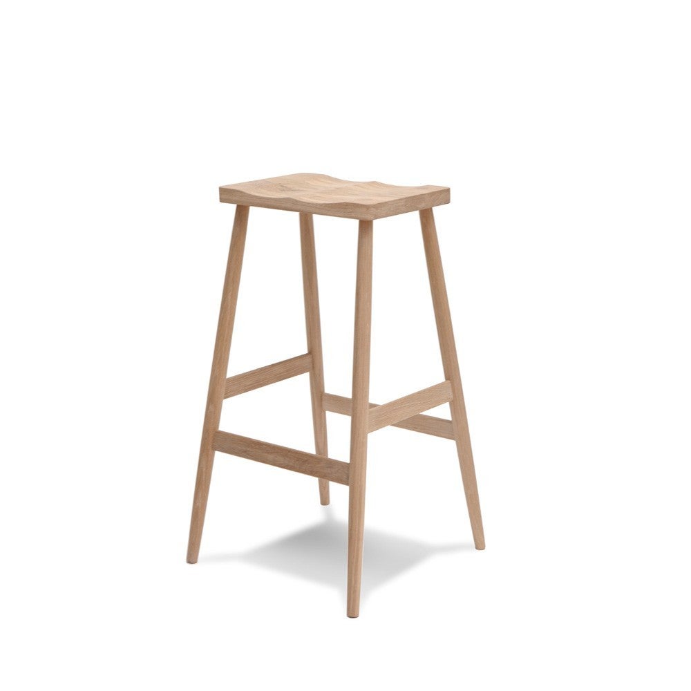 The Imo Barstool, designed by Russell Pinch, strikes a light and graceful pose. The legs are made from solid walnut and the oak seat is gently shaped to ensure a most comfortable sit.