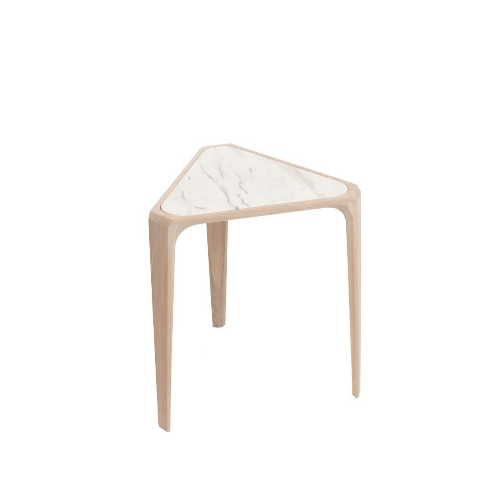 Mary's Side Table, crafted in solid hardwood with a marble top, is substantial yet delicate, sculptural yet highly functional. It was inspired by a visit to the Cathedral of St. Mary of the Assumption in San Francisco. Matthew Hilton was moved by