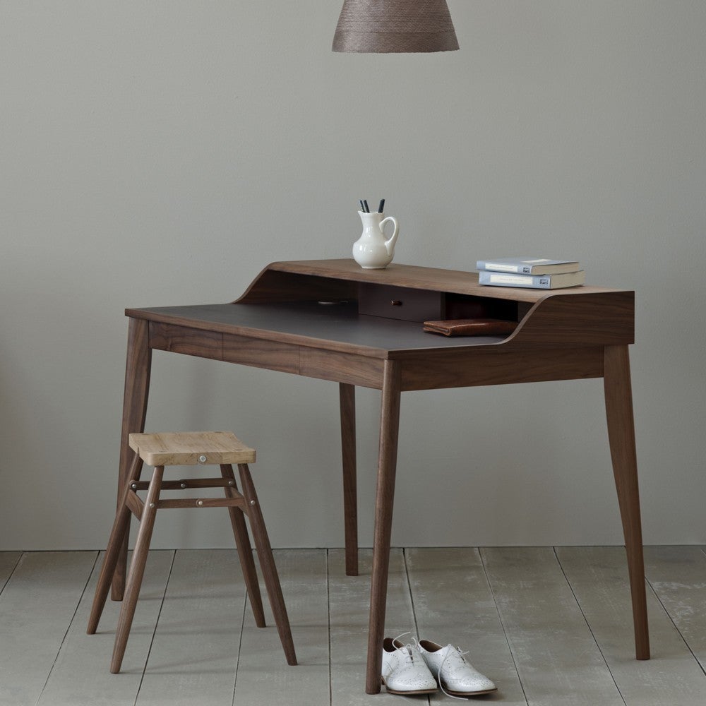 The Yves Desk has an inlaid leather writing surface, two drawers, and covered cable access holes. This desk comes with an Aubergine Leather top.