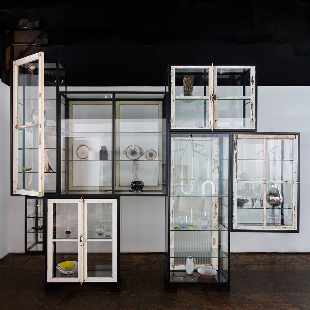 The Old Windows cabinet is a custom configurable glass shelving unit. Each version of the cabinet is one-of-a-kind. The two units featured here are the three and seven compartment cabinets. 

Dimensions and price listed are for 7 Compartment