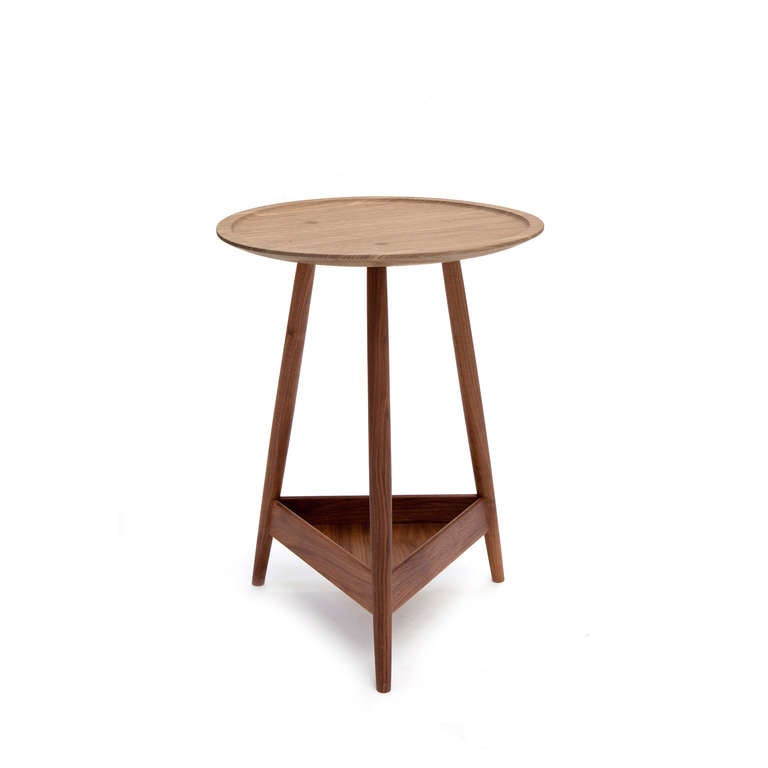 The Clyde, a three-legged occasional table with a turned solid wood top and triangular shelf below, is a great addition to any living space. 

Price listed is for Solid black American Walnut base with an Oak top.